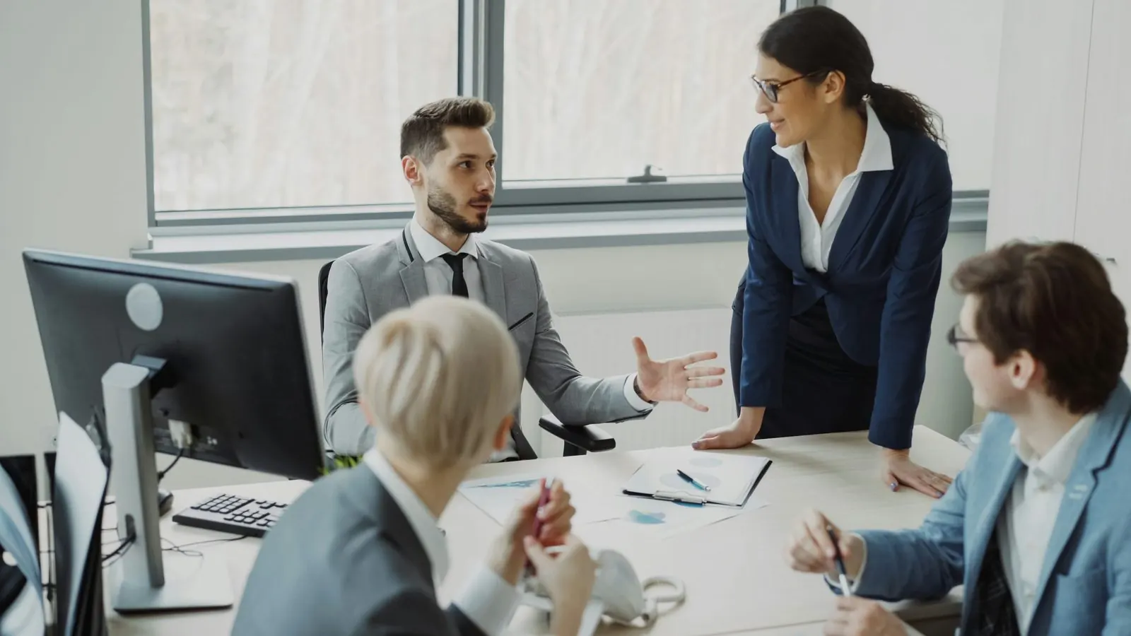 Business team collaborating around an office desk