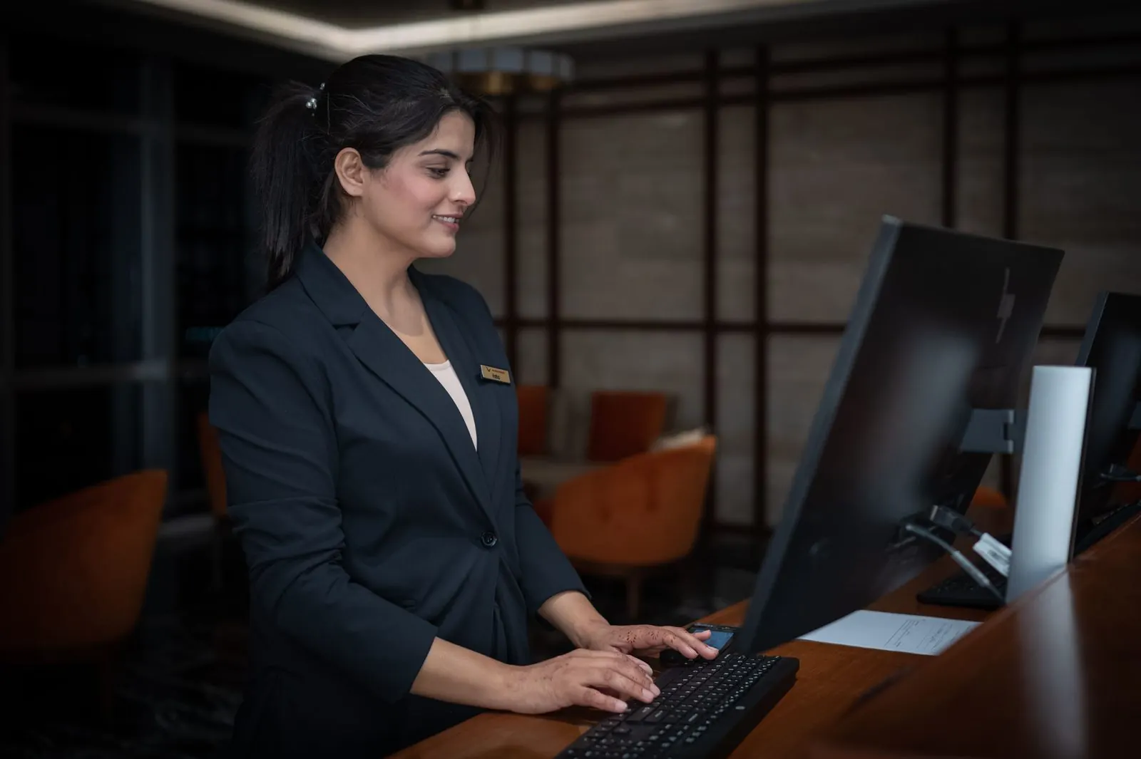 Hotel front-desk professional using a computer